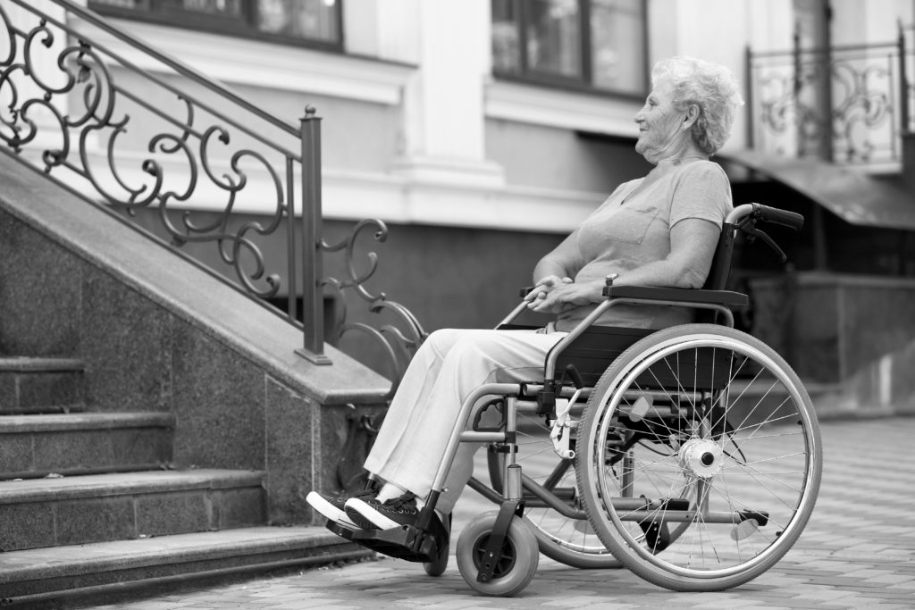A wheelchair user at bottom of steps